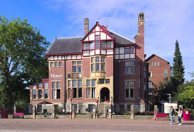 The Moco Museum in the red-brick Villa Alsberg on Honthorststraat, with half-timbered gables and a tower