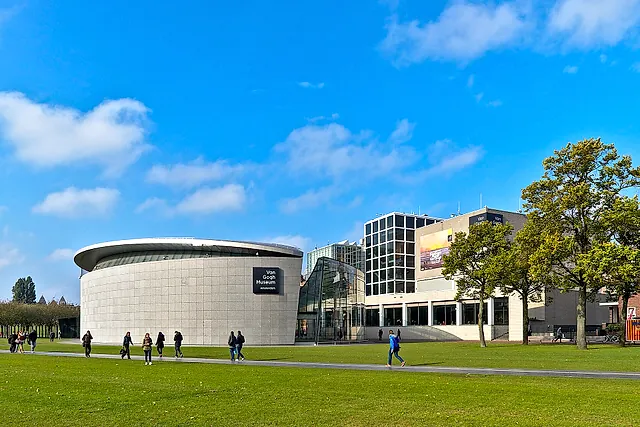 The Van Gogh Museum seen across the lawn of Museumplein: the oval main building next to the glass-fronted Kurokawa exhibition wing